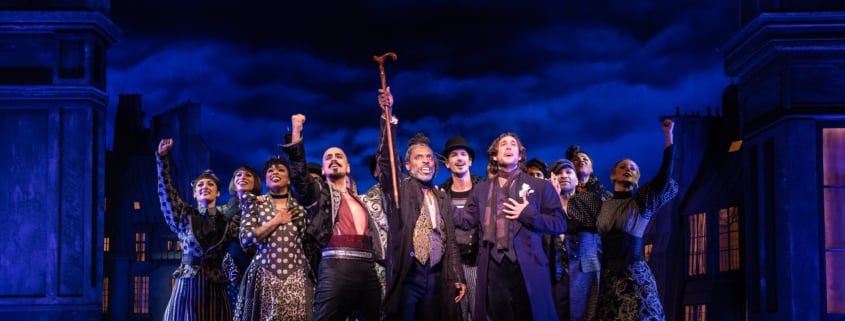 The cast of Moulin Rouge poses at the front of the stage