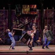 The cast of STOMP plays musical instruments onstage