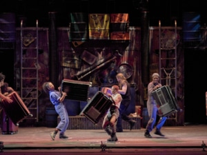 The cast of STOMP plays musical instruments onstage