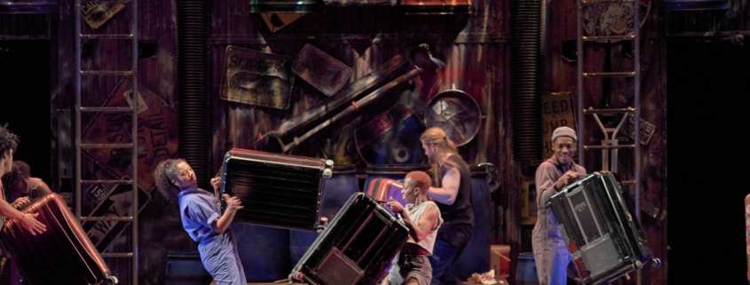 The cast of STOMP plays musical instruments onstage