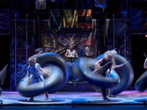 The cast of STOMP dance with inner tubes