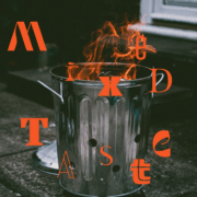 A garbage can with something on fire inside