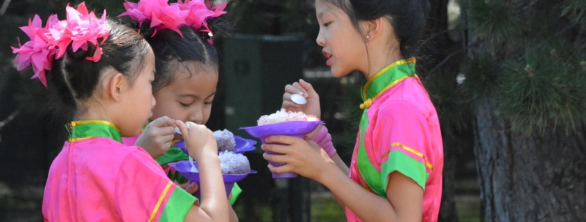 Three children enjoy shaved ice