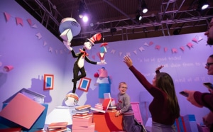 People interact with a Cat in the Hat exhibit