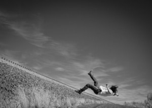 A person falling backwards of a cliff edge