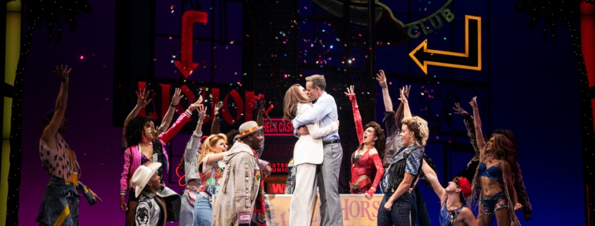 Vivian and Edward embrace surrounded by people in Pretty Woman: The Musical