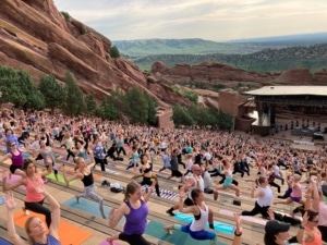 Hundreds of people do yoga at Red Rocks