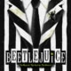Beetlejuice logo letters over an image of a black and white striped suite with a solid black tie