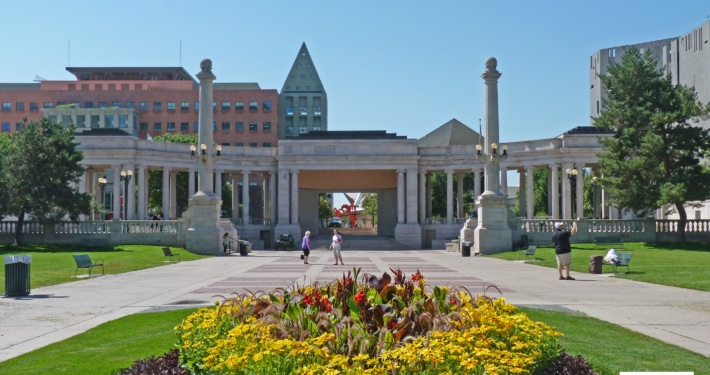 The Greek Theater and Colonnade of Civic Benefactors pictured with a large patch of flowers