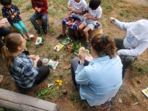 A woman leads discussion with a group of children