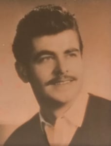 A sepia toned photograph of a young man