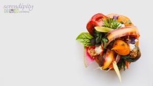 A colorful salad sits on a stark white table