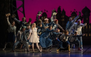 The cast of Wicked dances onstage with Glinda