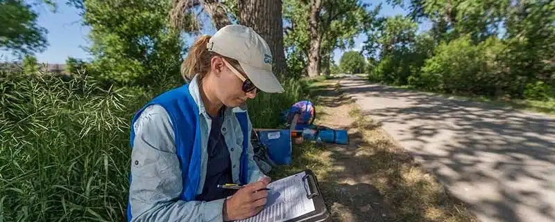 Denver Botanic Gardens ecologist records data during an ecological survey of an urban greenway in Denver