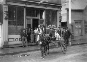 An old photograph of Denver's Chinatown with a horse cart in the street