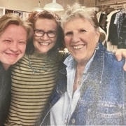 A photograph of three women smiling