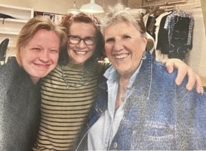 A photograph of three women smiling