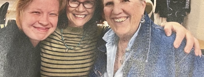 A photograph of three women smiling