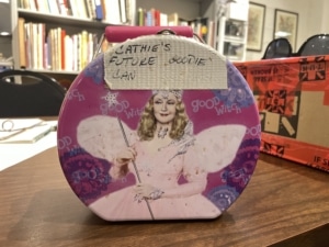 A pink Glinda lunchbox that reads Cathie's Future Goodie Can