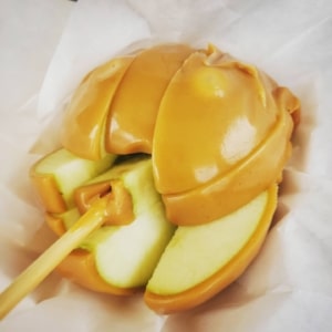 A close up of a sliced caramel apple