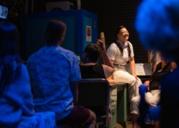 A person sits in front of an audience
