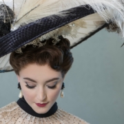 A woman in elegant dress with a large feathered hat