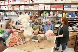 The props team stands around some of their projects