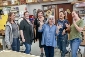 The props team poses while laughing for a photo