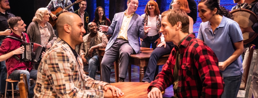 The cast of Come From Away sings together onstage