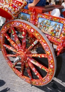 A colorful wheel on a horse drawn cart