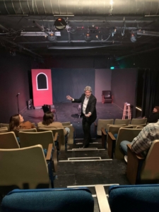 A comedian performs in the aisle at the Jester's Palace