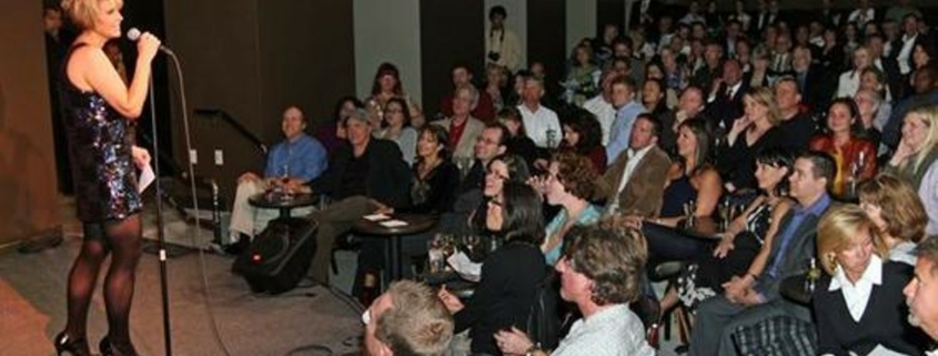 A comedian stands onstage at Comedy Works