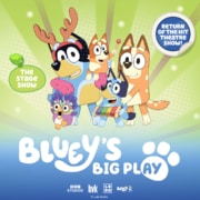 A graphic featuring illustrated characters from the Bluey animated series. On a bright green and blue background, Bluey holds a xylophone and Bingo wears a feathered costume. Decorative badges read “THE STAGE SHOW” and “RETURN OF THE HIT THEATRE SHOW!” at the top corners. The title “Bluey’s Big Play” appears prominently at the bottom in large white lettering.