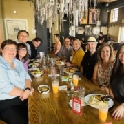 Staff members of the DCPA sit at a table and smile for a photo