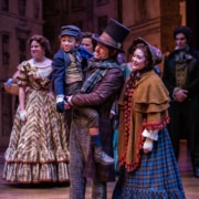 The cast of A Christmas Carol stands together onstage