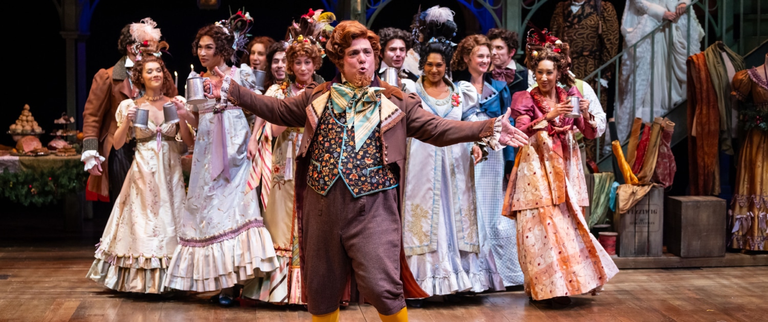  group of actors in period costumes performing on stage.
