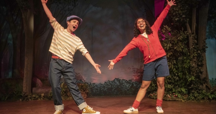 Shepard Boy and Little Red pose with their arms stretched