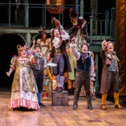 The cast of A Christmas Carol sings onstage