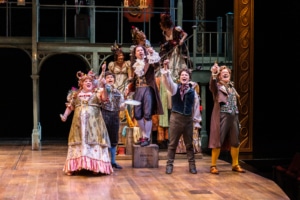 The cast of A Christmas Carol sings onstage