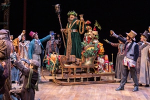 The ghost of Christmas Present raises a glass in A Christmas Carol