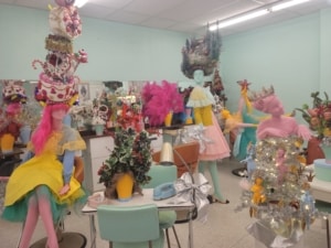 A room filled with colorful mannequins styled like a salon