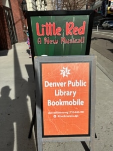 A sign for the Denver Public Library Bookmobile next to a sign for LITTLE RED