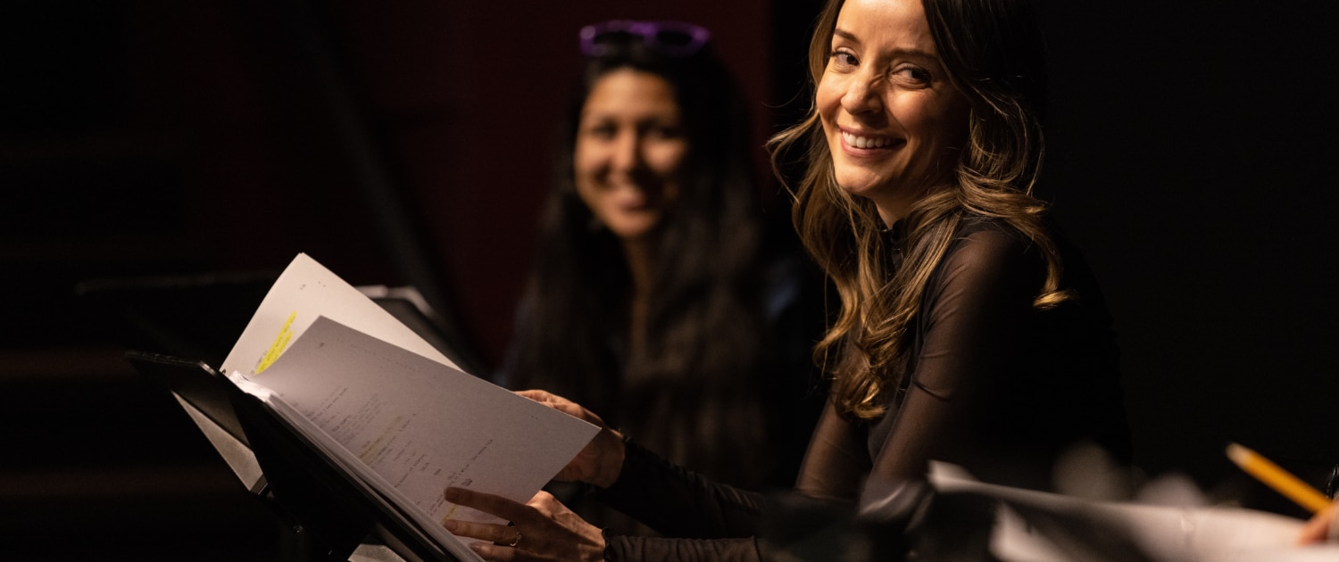 Jamie Ann Romero smiles onstage during Cebollas rehearsal