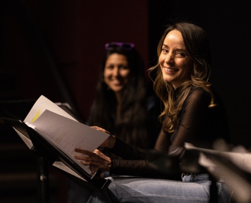 Jamie Ann Romero smiles onstage during Cebollas rehearsal