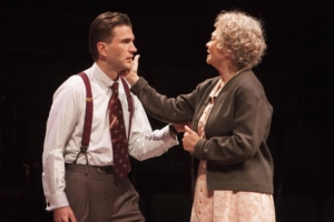 A woman reaches for a man's cheek in Death of a Salesman