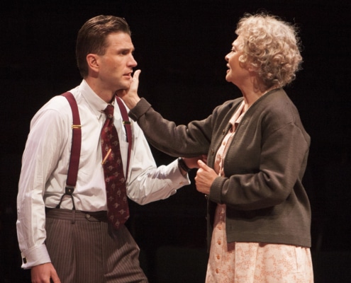 A woman reaches for a man's cheek in Death of a Salesman