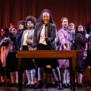 The cast of 1776 stands onstage as they sing