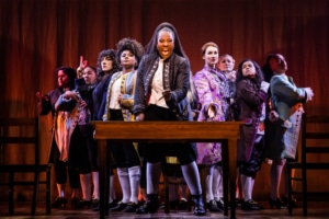 The cast of 1776 stands onstage as they sing