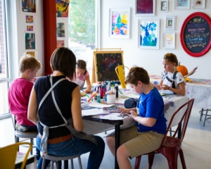 Children work at a table at artSPARK