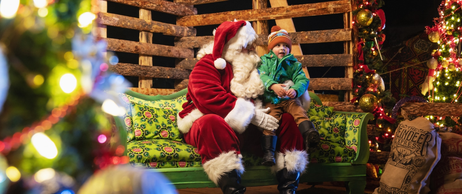 A child sits on Santa's lap at Camp Christmas